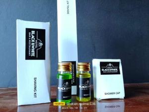 three bottles of essential oils sitting on a table at Hotel Black and White International in Bhairāhawā