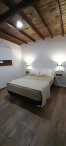 a bedroom with a bed and two lights on the wall at Duplex La Caleta Mar in Mar de Cobo