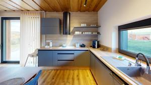 a kitchen with a sink and a counter with a window at Chalet pod Skalou in Liptovská Anna