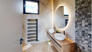 a bathroom with two sinks and a mirror at Chalet pod Skalou in Liptovská Anna +19 photos