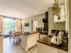 a kitchen with a sink and a table with a dining room at 1 Bed in Stoke-on-trent oc-89733 in Waterhouses