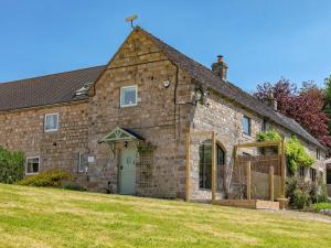 an old stone house with a green door at 1 Bed in Stoke-on-trent oc-89733 in Waterhouses