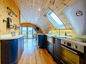 a kitchen with blue cabinets and a skylight at 2 Bed in Rhayader oc-90274 in Saint Harmon +13 photos