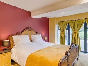 a bedroom with a large bed with red walls at 2 Bed in Stoke-on-trent oc-94790 in Waterhouses
