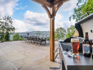 a patio with chairs and a table with beer bottles at 7 Bed in Matlock oc-89448 in Matlock Bank