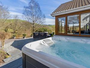 a hot tub in the backyard of a house at 4 Bed in Llanidloes oc-95968 in Van