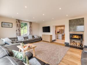 a living room with a couch and a fireplace at 7 Bed in Matlock oc-89448 in Matlock Bank