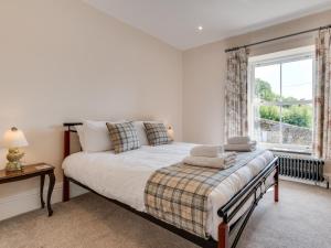 a bedroom with a large bed and a window at 7 Bed in Matlock oc-89448 in Matlock Bank