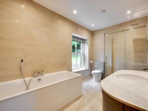 a bathroom with a tub and a sink and a toilet at 7 Bed in Matlock oc-89448 in Matlock Bank +36 photos