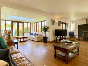 a living room with a couch and a tv at 3 Bed in Walberswick oc-htroy2 in Walberswick