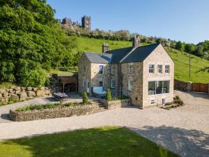 a large stone house with a garden in front of it at 7 Bed in Matlock oc-89448 in Matlock Bank