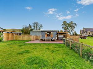 a caravan in a yard with a fence at 1 Bed in Rhayader oc-90284 in Saint Harmon