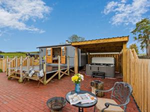 a backyard with a trailer with a table and a fence at 1 Bed in Rhayader oc-90284 in Saint Harmon