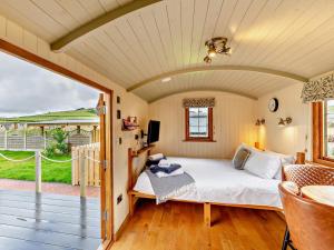 a bedroom with a bed and a balcony at 1 Bed in Rhayader oc-90284 in Saint Harmon +13 photos