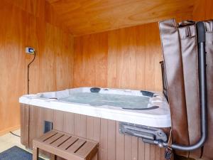 a hot tub in a room with a wooden wall at 2 Bed in Llandrindod Wells oc-89063 in Nantmel +19 photos
