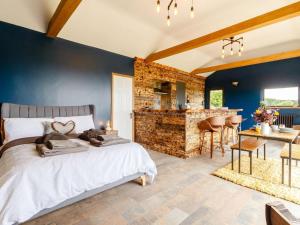a bedroom with a king sized bed and a kitchen at 1 Bed in Abergavenny oc-88015 in Llanover