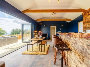 a living room with a stone wall and a table and chairs at 1 Bed in Abergavenny oc-88015 in Llanover