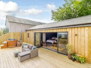 a patio with a couch and a bed on a deck at 1 Bed in Abergavenny oc-88015 in Llanover +20 photos