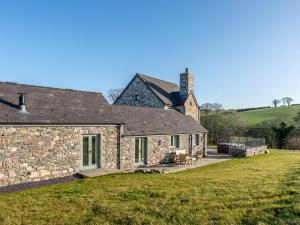 an old stone house with a grass yard at 4 Bed in Denbigh oc-62947 in Llannefydd