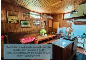 a kitchen with a counter and a table in a room at Gioz87 in Gioz