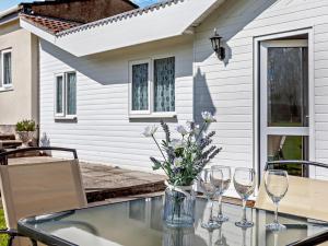 a table with wine glasses and flowers on a patio at 2 Bed in Bristol oc-05135 in Chew Magna +16 photos