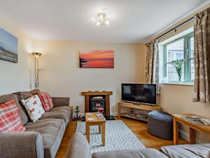 a living room with a couch and a television at 3 Bed in Watchet oc-83532 in Watchet