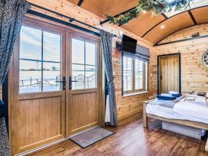a bedroom with a bed and a large door at 1 Bed in Rhayader oc-90285 in Saint Harmon