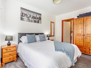 a bedroom with a white bed and a wooden cabinet at 2 Bed in Bristol oc-37147 in Chew Magna