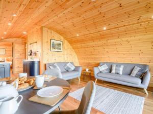 a living room with a table and a couch at 2 Bed in Rhayader oc-90280 in Saint Harmon