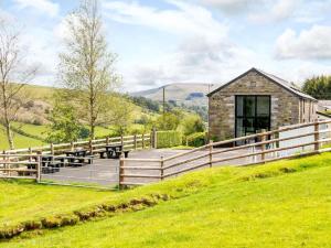 a house on a hill with a wooden fence at 1 Bed in Brecon oc-bn034 in Cray
