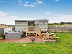a tiny caravan with a deck and a patio at 1 Bed in Rhayader oc-90277 in Saint Harmon