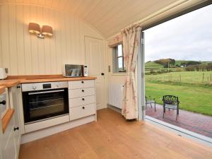 a kitchen with a stove and a large window at 1 Bed in Rhayader oc-90277 in Saint Harmon +19 photos