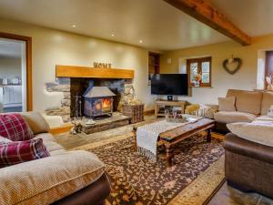 a living room with a fireplace and a couch at 4 Bed in Abergavenny oc-88014 in Llanover