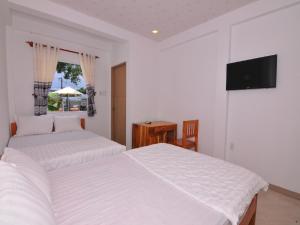 Giường trong phòng chung tại Orchid Guesthouse