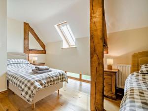 a bedroom with two beds and a window at 3 Bed in Crickhowell oc-bn124 in Tretower