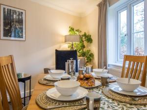 a dining room with a table with dishes on it at 3 Bed in Bampton oc-77931 in Bampton +13 photos