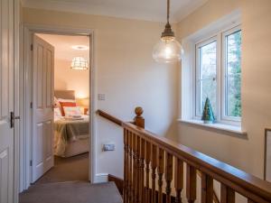 a hallway with a staircase leading to a bedroom at 3 Bed in Bampton oc-77931 in Bampton