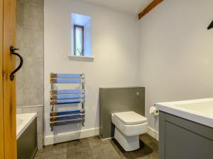 a bathroom with a toilet and a sink and a bath tub at 3 Bed in Brecon oc-88249 in Brecon +19 photos