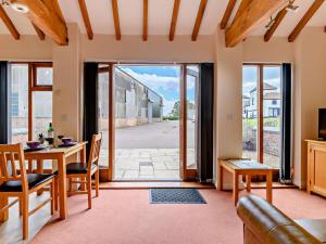a living room with a table and chairs and a glass door at 1 Bed in Doncaster oc-93151 in Mattersey