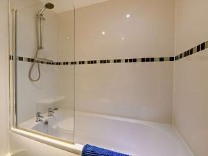 a bathroom with a tub and a glass shower at 1 Bed in Doncaster oc-93151 in Mattersey +21 photos