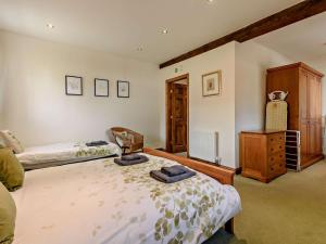a bedroom with two beds and a dresser in it at 2 Bed in Doncaster oc-93150 in Mattersey