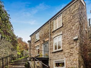 an old brick house with stairs leading up to it at 2 Bed in Brecon oc-92729 in Brecon