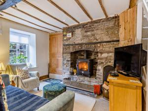 a living room with a large stone fireplace at 2 Bed in Brecon oc-92729 in Brecon