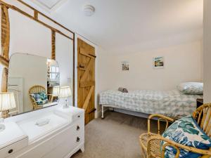 a bedroom with a bed and a dresser and a mirror at 2 Bed in Brecon oc-92729 in Brecon