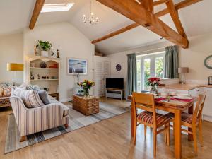 a living room with a wooden table and a dining room at 1 Bed in Derby oc-76518 in Tutbury