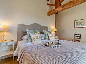 a bedroom with a bed with a blue and white bedspread at 1 Bed in Derby oc-76518 in Tutbury