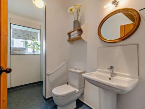 a bathroom with a toilet and a sink and a mirror at 1 Bed in Derby oc-76518 in Tutbury +15 photos