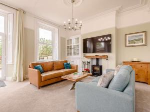 a living room with two couches and a fireplace at 4 Bed in Matlock oc-88011 in Matlock