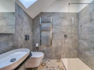 a bathroom with a toilet and a sink and a shower at 4 Bed in Denbigh oc-76475 in Llannefydd +35 photos