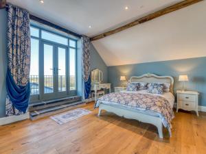a bedroom with a bed and a large window at 4 Bed in Denbigh oc-76475 in Llannefydd